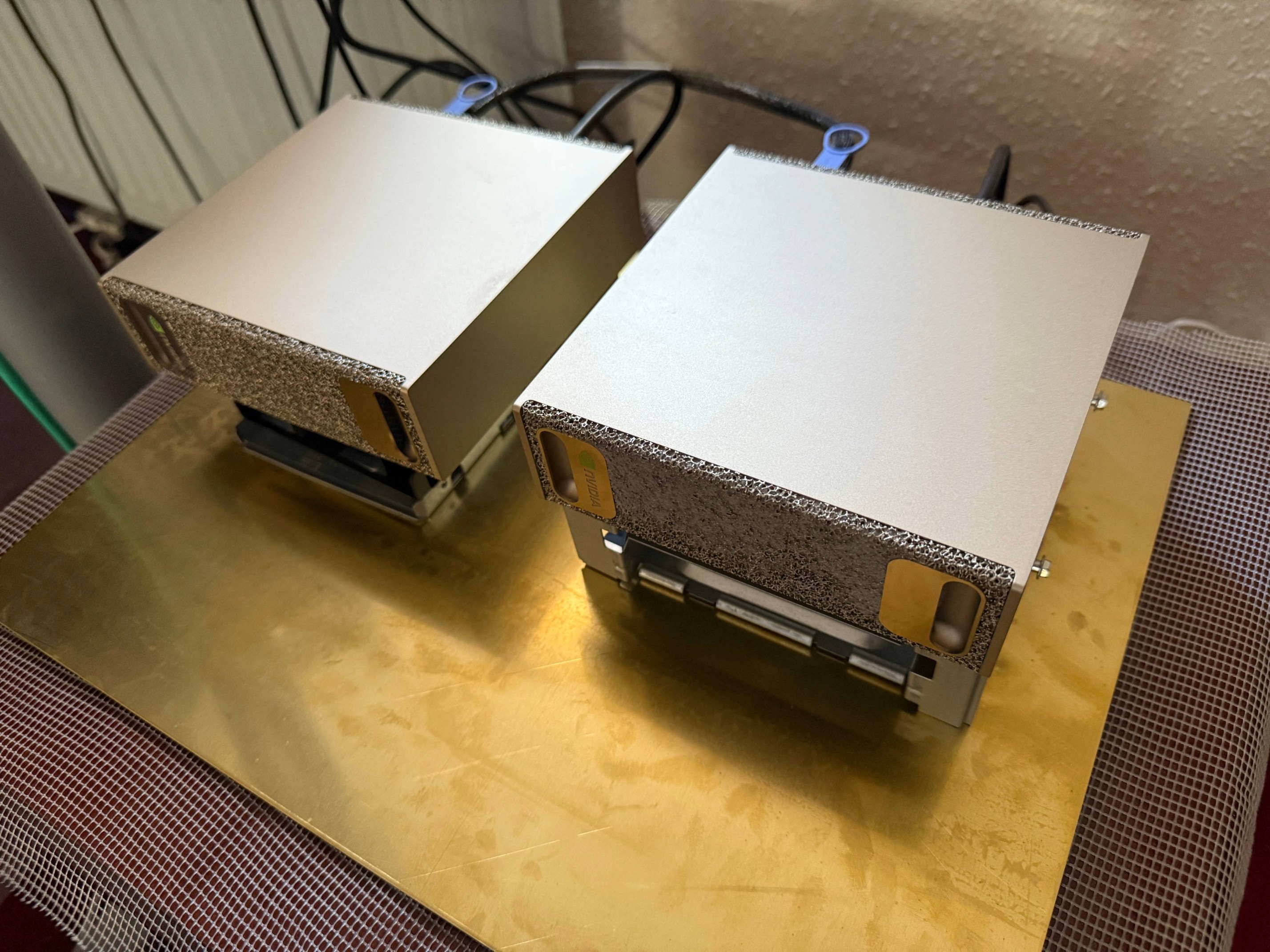 Two NVIDIA DGX Sparks side-by-side, connected via a QSFP112 cable